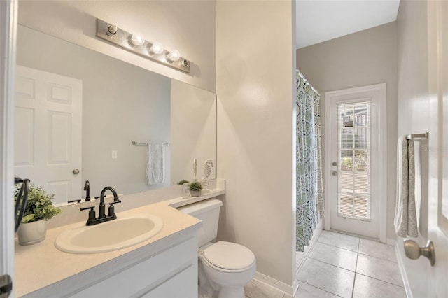 bathroom featuring tile patterned flooring, vanity, and toilet