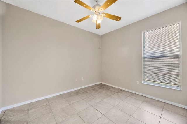 spare room with light tile patterned floors, ceiling fan, and a healthy amount of sunlight