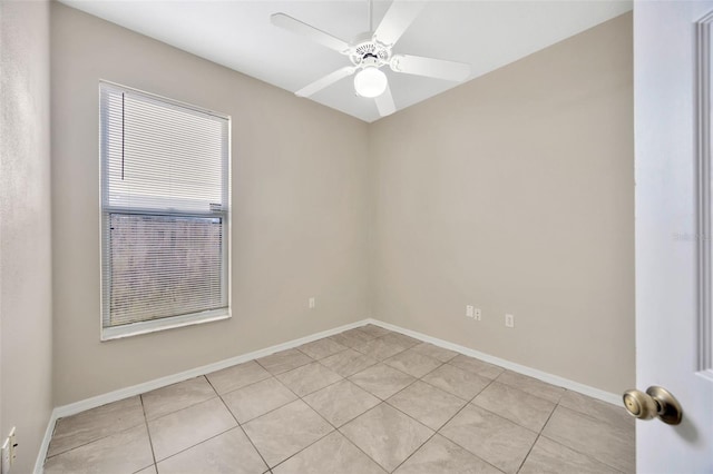 tiled spare room with ceiling fan