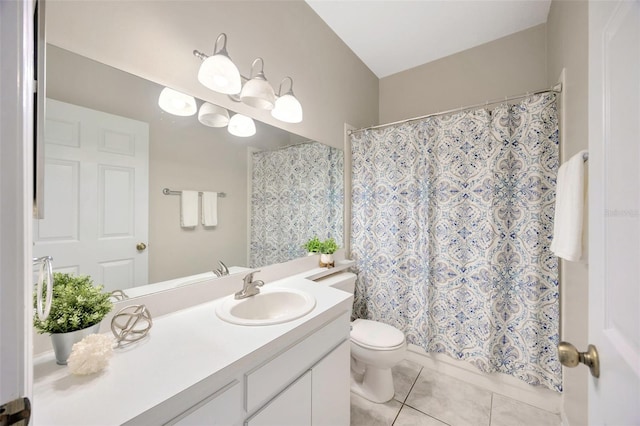 bathroom with tile patterned flooring, vanity, and toilet