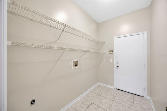 laundry room with hookup for an electric dryer, washer hookup, and light tile patterned flooring