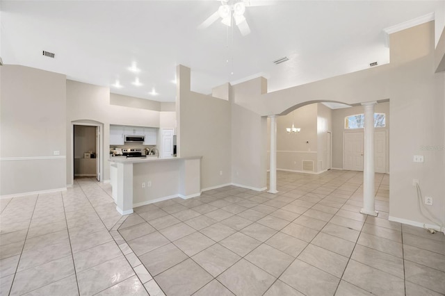 interior space featuring ceiling fan with notable chandelier