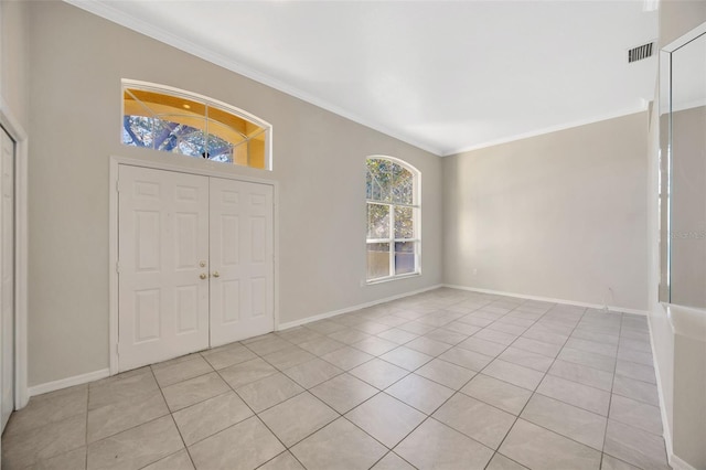 tiled foyer entrance featuring ornamental molding