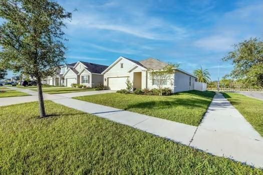 single story home with a garage and a front yard