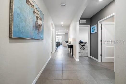 hall featuring light tile patterned flooring