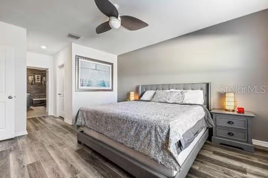 bedroom with ceiling fan and dark hardwood / wood-style floors