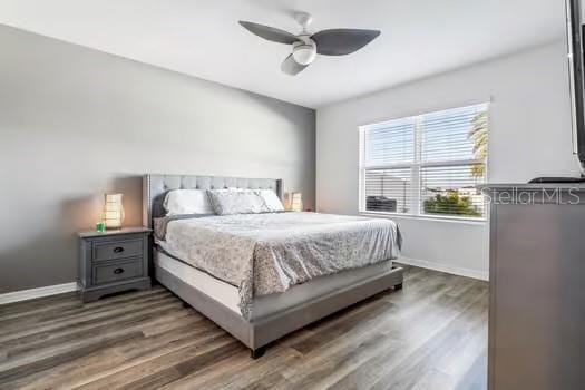 bedroom featuring ceiling fan and dark hardwood / wood-style flooring