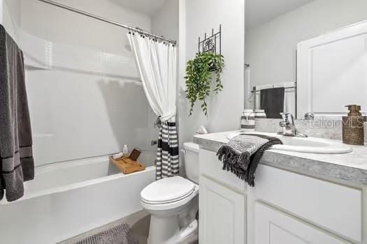 full bathroom with vanity, toilet, and shower / tub combo