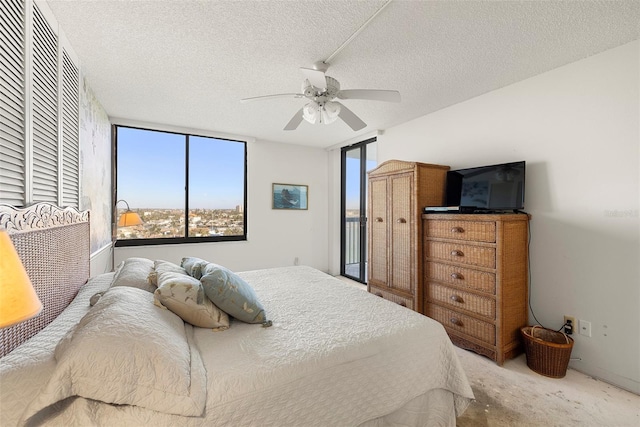 carpeted bedroom with ceiling fan and a textured ceiling