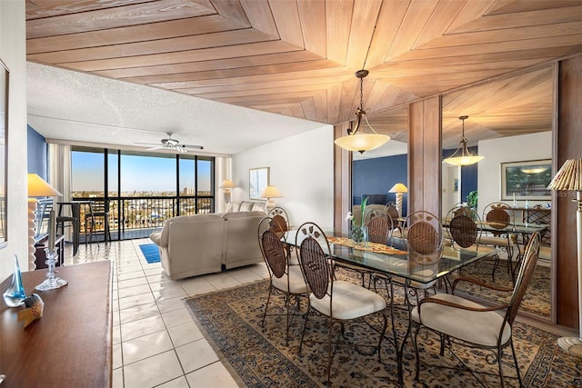 dining space featuring ceiling fan, wooden ceiling, and light tile patterned floors