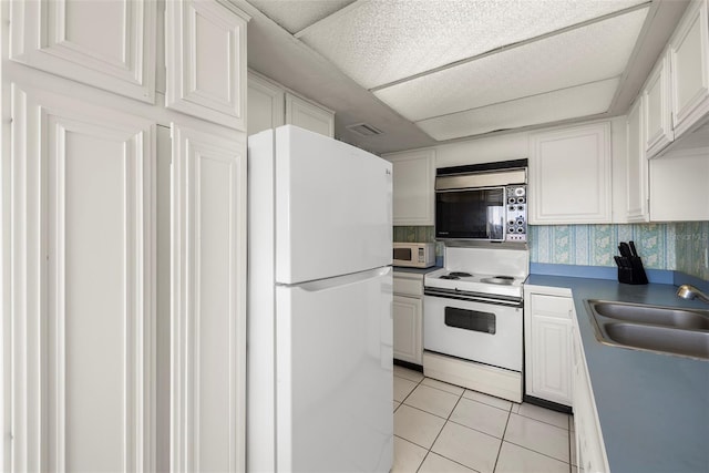 kitchen with decorative backsplash, white cabinetry, sink, and white appliances