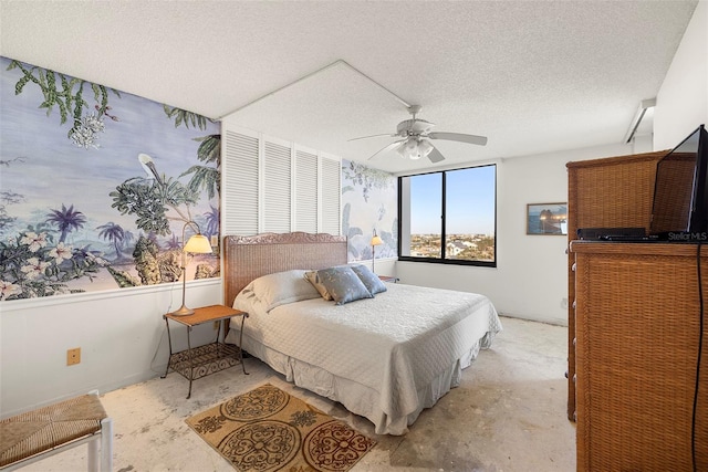 bedroom with ceiling fan and a textured ceiling