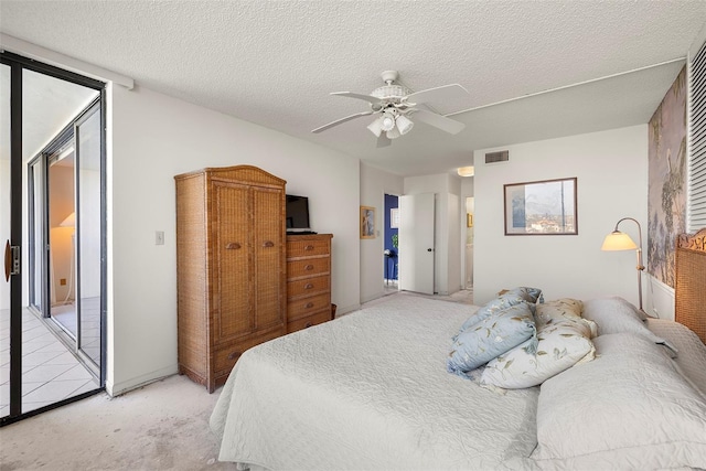 carpeted bedroom with a textured ceiling, access to outside, and ceiling fan