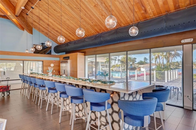 kitchen with pendant lighting, wooden ceiling, high vaulted ceiling, and high end refrigerator