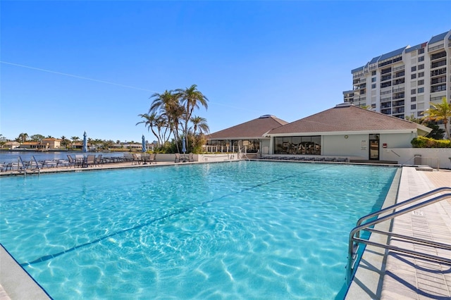 view of swimming pool with a water view