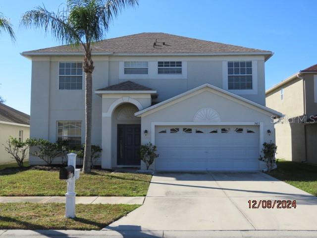 view of front property with a front yard and a garage