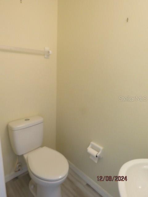 bathroom featuring toilet and hardwood / wood-style flooring