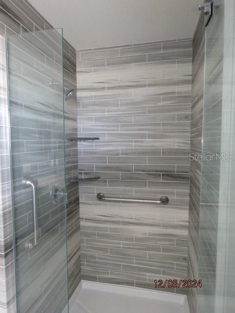 bathroom with a shower with shower door