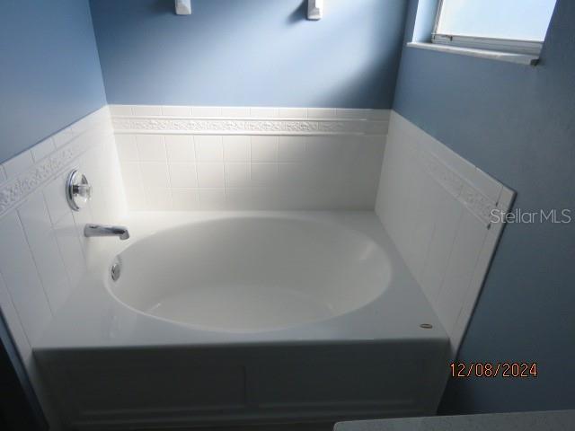 bathroom featuring a tub to relax in