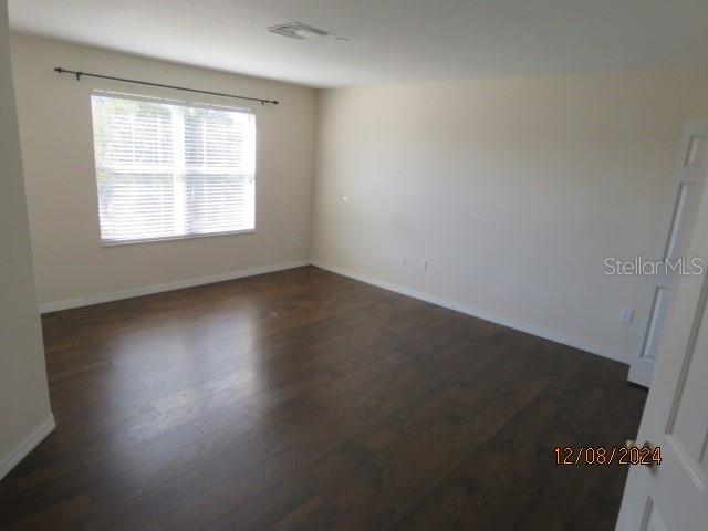 empty room with dark wood-type flooring