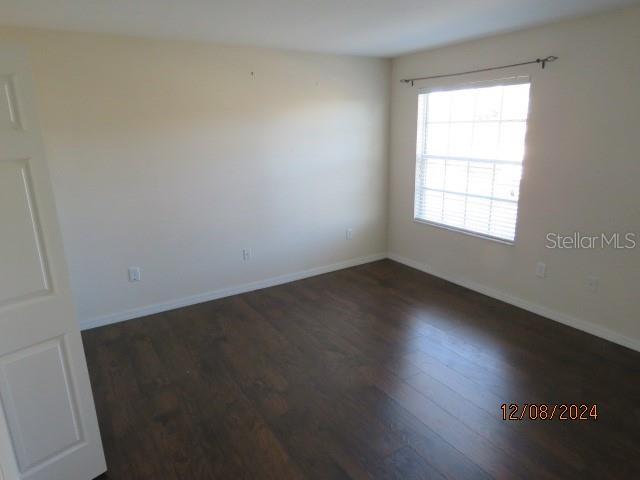 empty room featuring dark hardwood / wood-style flooring