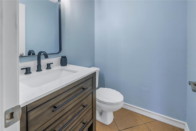 bathroom with tile patterned floors, vanity, and toilet