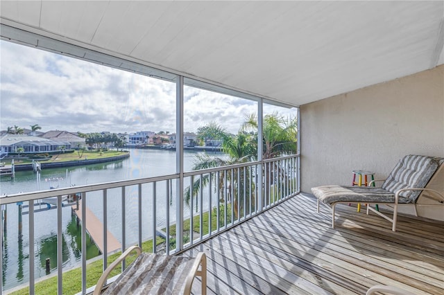 sunroom / solarium with plenty of natural light and a water view