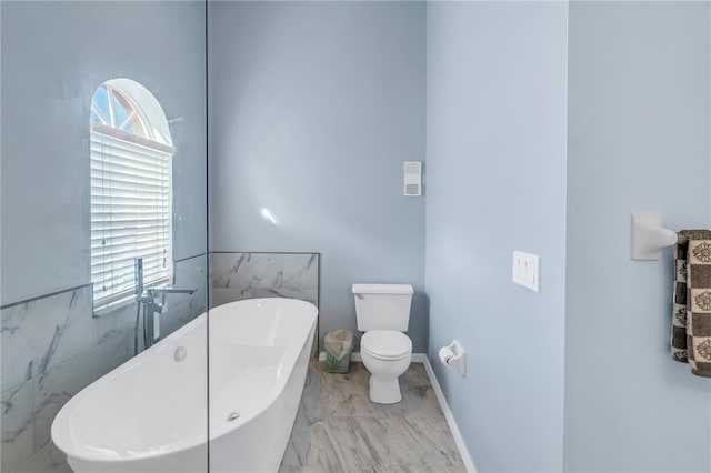 bathroom featuring plenty of natural light, a bath, tile walls, and toilet