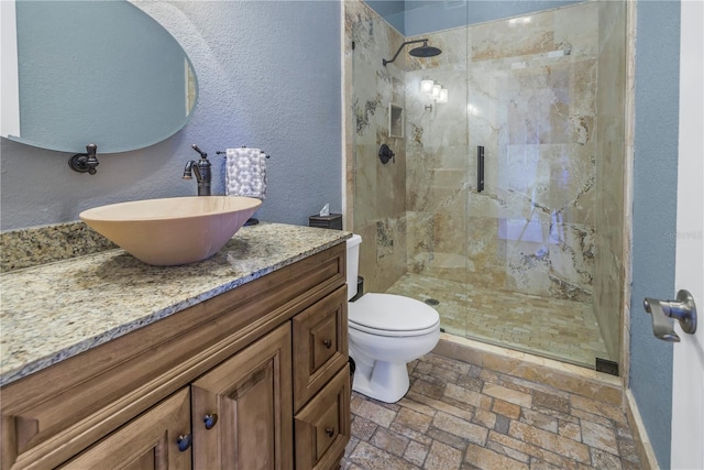 bathroom featuring vanity, toilet, and an enclosed shower