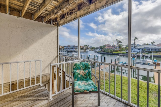 balcony featuring a boat dock and a water view