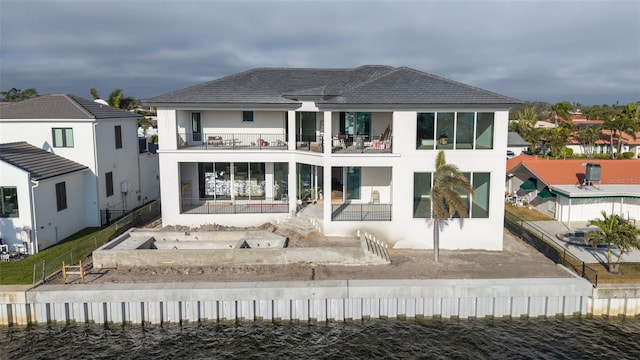 back of house featuring a balcony