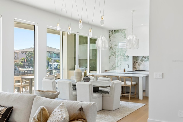 dining space featuring sink and hardwood / wood-style floors