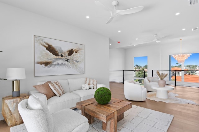 living room featuring ceiling fan and light wood-type flooring