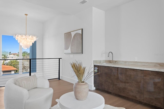 interior space featuring an inviting chandelier, sink, and dark hardwood / wood-style flooring