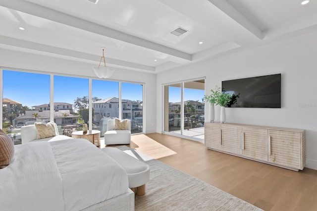 bedroom featuring access to outside, light hardwood / wood-style floors, and beamed ceiling