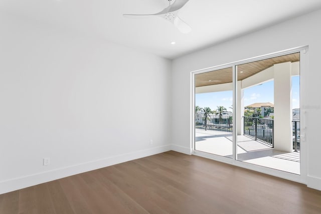 empty room with hardwood / wood-style floors and ceiling fan