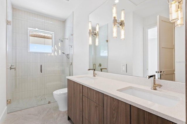 bathroom featuring vanity, toilet, and a shower with shower door