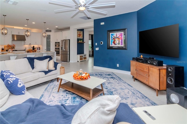 living room featuring light tile patterned floors and ceiling fan