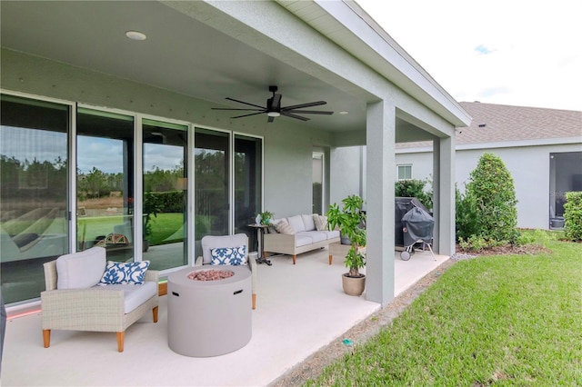 view of patio / terrace featuring ceiling fan, a grill, and an outdoor living space with a fire pit