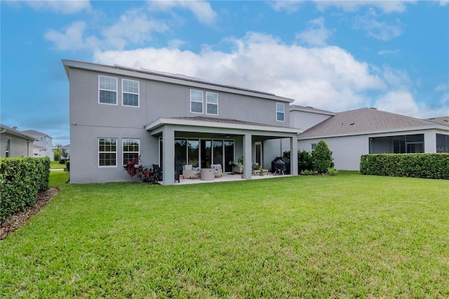 back of house featuring a patio and a yard