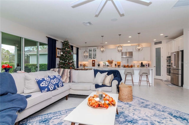 tiled living room featuring ceiling fan