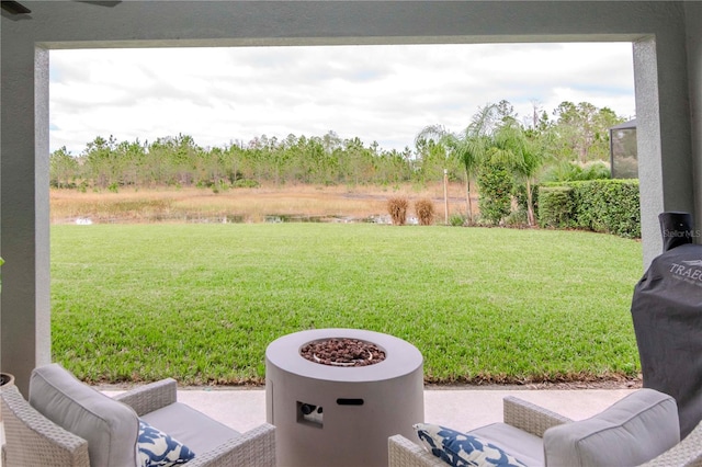 view of yard featuring a patio and an outdoor fire pit