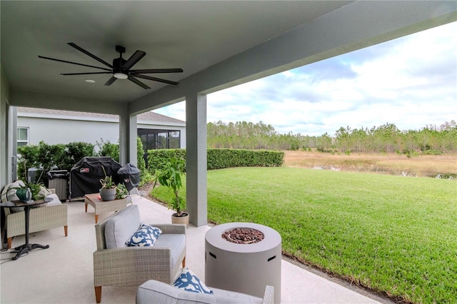 view of patio with ceiling fan, a grill, and a fire pit