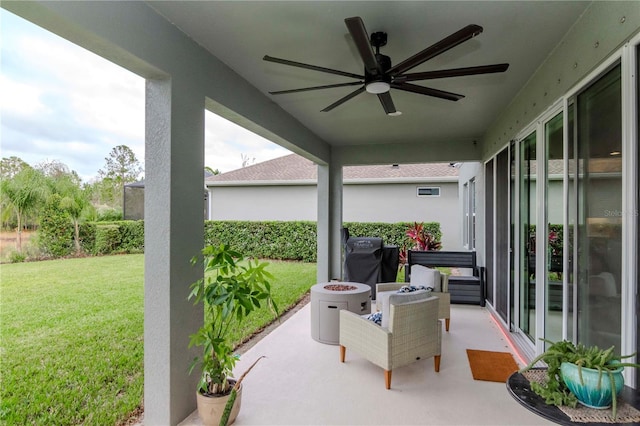 view of patio / terrace with a fire pit and ceiling fan