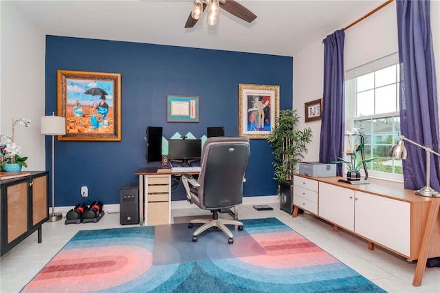 home office featuring light tile patterned floors, baseboards, and ceiling fan