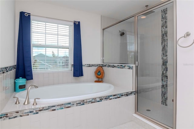 full bathroom with a shower stall and a garden tub