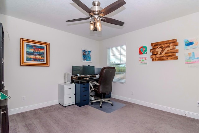 home office with light carpet, ceiling fan, and baseboards