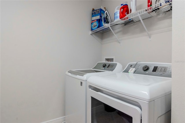 clothes washing area with laundry area and washer and dryer