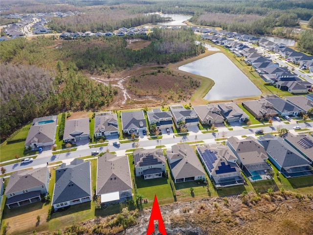 birds eye view of property featuring a water view and a residential view