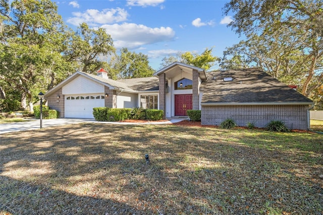 view of front of home with a front yard and a garage